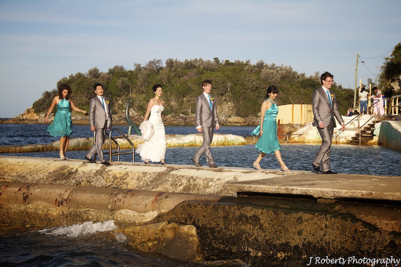Bridal party walking in line at sunset - wedding photography